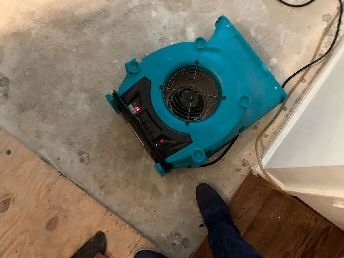 Air mover drying subfloor during Commercial Water Damage Restoration in Vernon Hills